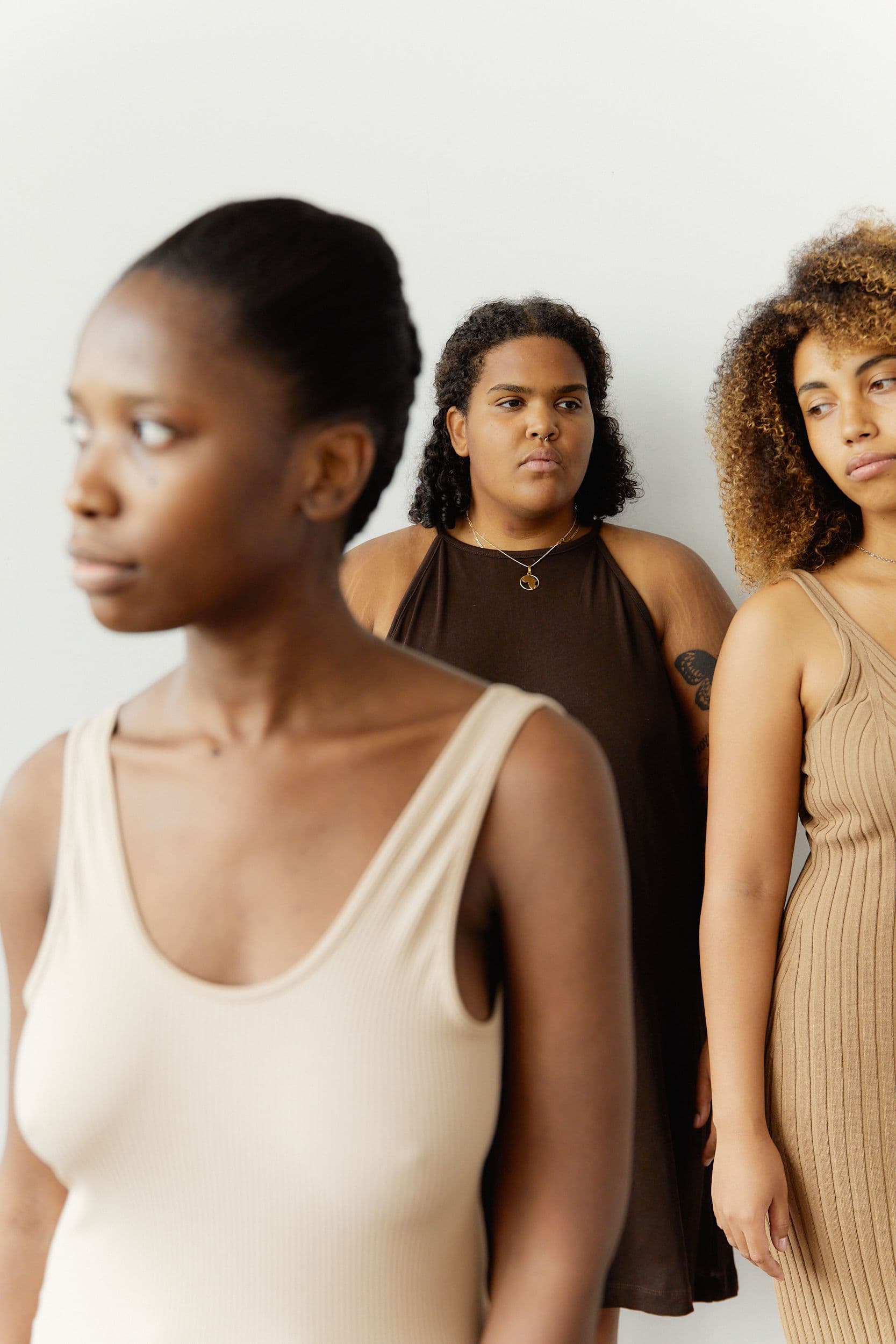 Three women with serious, contemplative expressions β 1 in 3 experience lasting health problems after childbirth